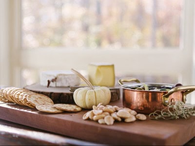 Warm fall tablescape with pumpkins, cozy textures, and seasonal decor — representing a calm, organized home ready for the holidays.